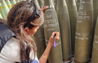 ABD'nin BM eski Temsilcisi Haley, İsrail ziyaretinde top mermisine "Bitirin onları" yazdı