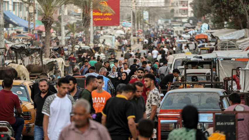 İsrail-Hamas savaşı nedeniyle yerlerinden edilen Filistinliler 30 Ekim 2023'te Gazze Şeridi'nin güneyindeki Han Yunus'ta bir pazarda alışveriş yapıyor (Fotoğraf: Yousef Masoud/The New York Times)
