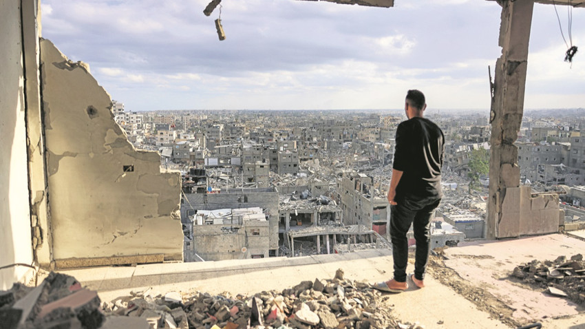 Gazze Şeridi’ndeki Han Yunus’ta bir adam bombardımanın yerle bir ettiği kentine bakıyor. Fotoğraf: Bashar Taleb / AFP via Getty Images